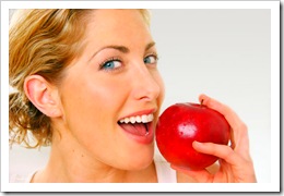 happy-woman-eating-red-apple